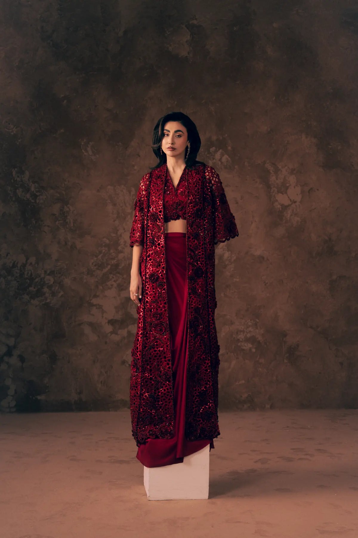 Crimson formal dress for women with sequin cutwork jacket, embroidered V-neck blouse and draped skirt, full length front view