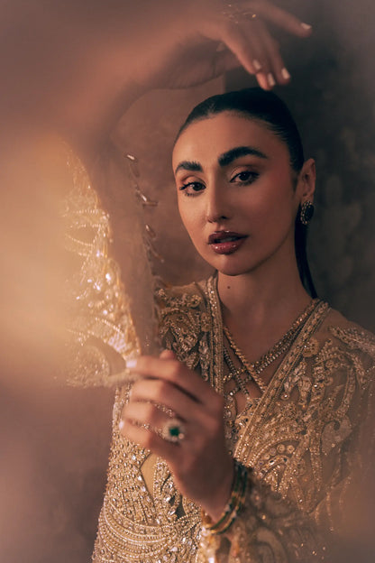 Close-up of criss-cross neckline and gold sequin, pearl and crystal embroidery on Ivory Opulence Pakistani formal dress
