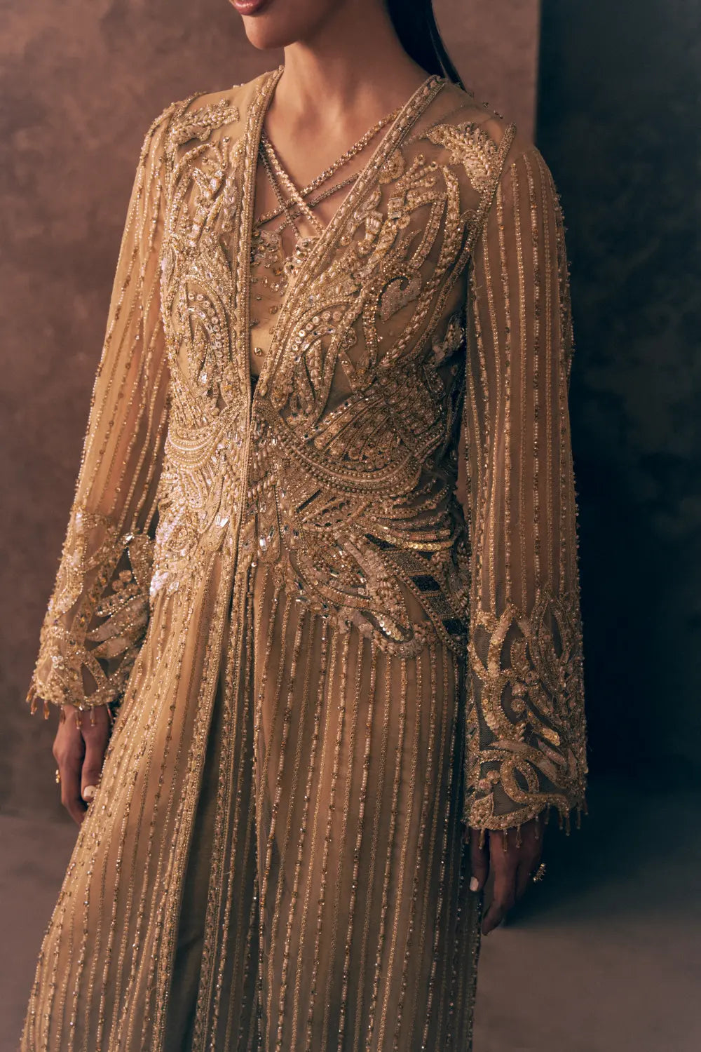 Detail of Ivory Opulence Pakistani wedding guest dress with embroidered waist, bell sleeves and beaded stripe net jacket