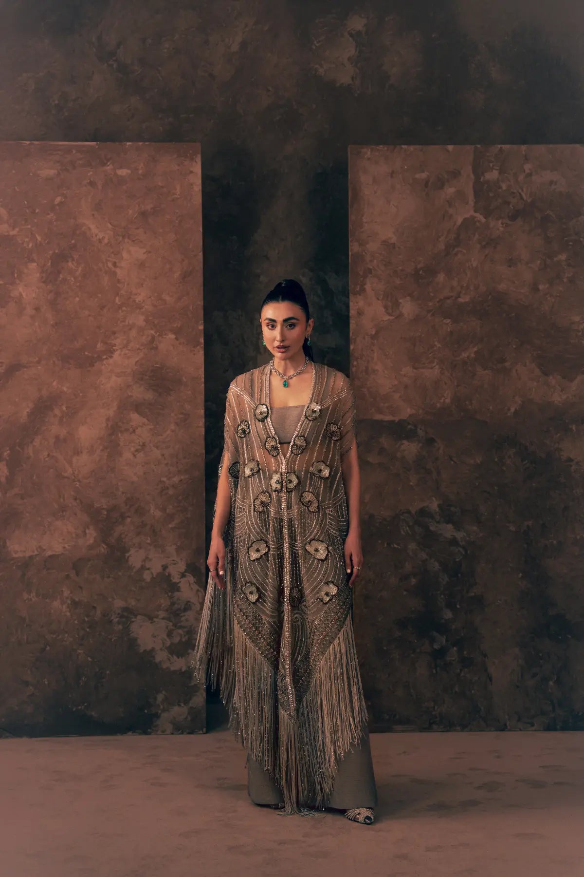Woman wearing Vestis Pret Lunar Grace 3 piece Pakistani formal dress with beaded net cape, bandeau blouse and wide-leg trouser, front view
