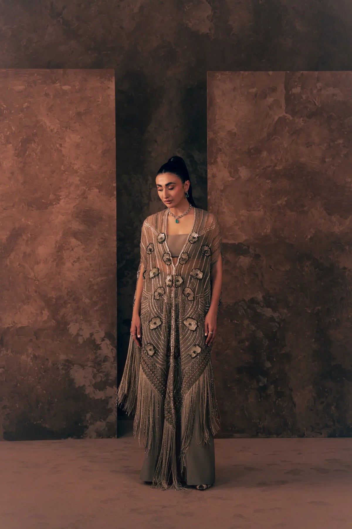 Full-length view of Vestis Pret Lunar Grace 3 piece formal dress with sheer embroidered net cape, blouse and taupe trouser