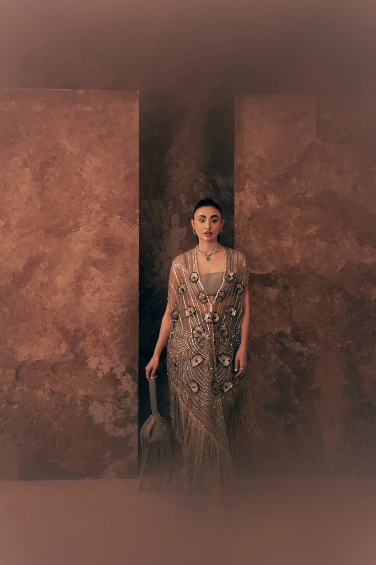 Lunar Grace Pakistani party wear dress with embroidered net cape and trouser, styled with a fringed potli bag