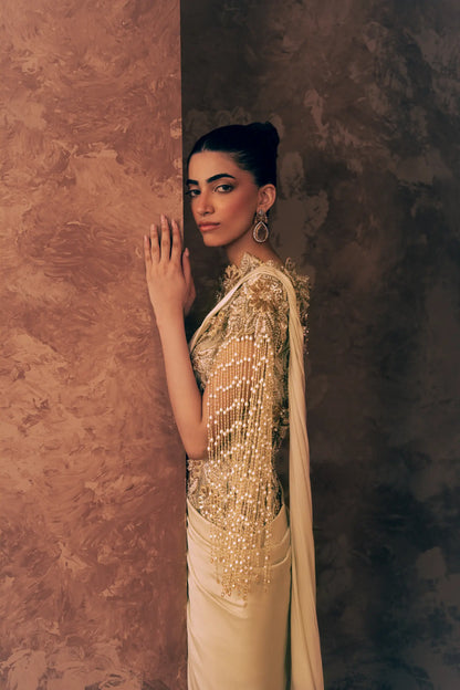 Side profile of Pearl Drapes formal dress showing pearl and crystal fringe sleeve, embroidered high neckline and satin silk drape